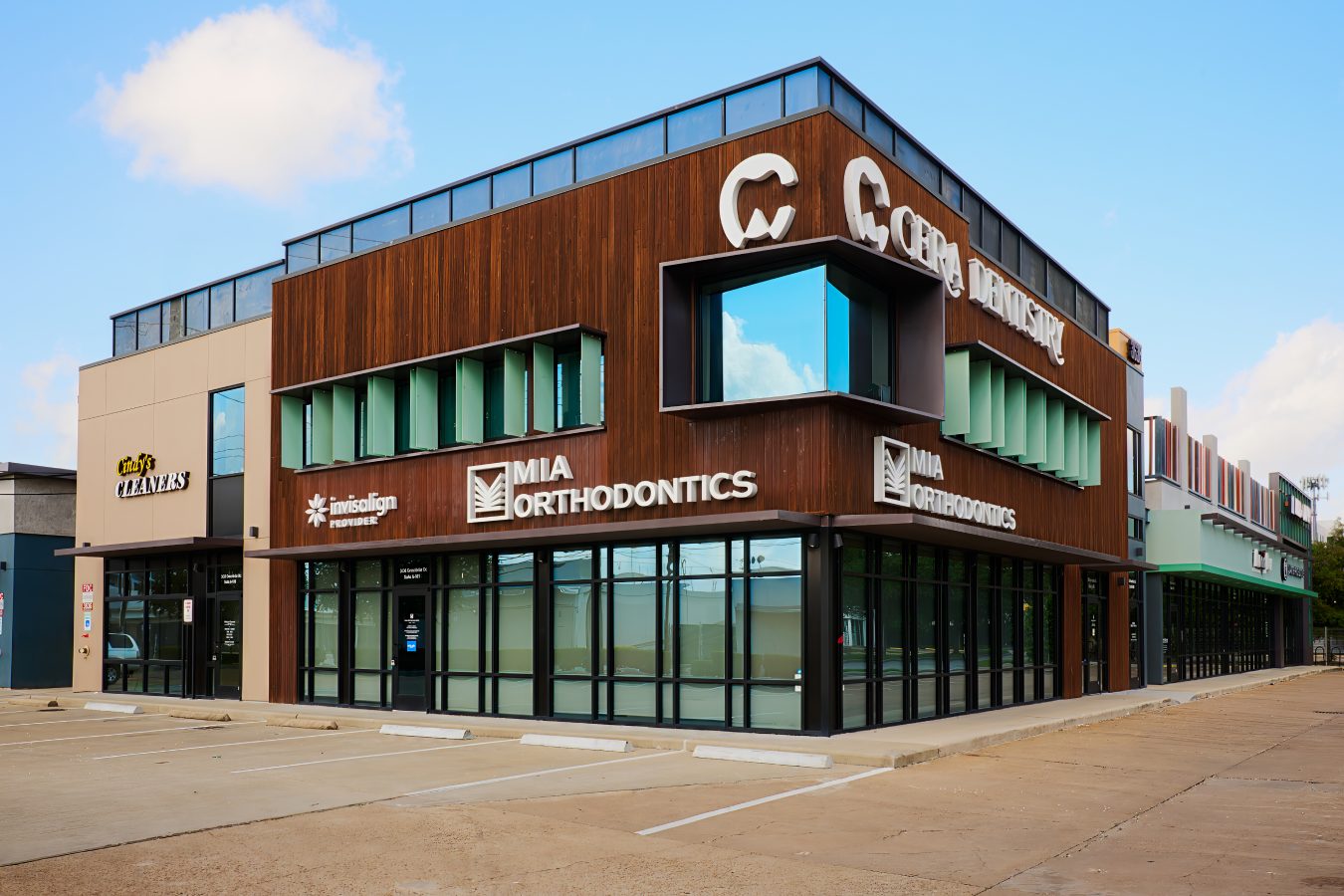 Contemporary orthodontic clinic building with wooden and glass exterior.