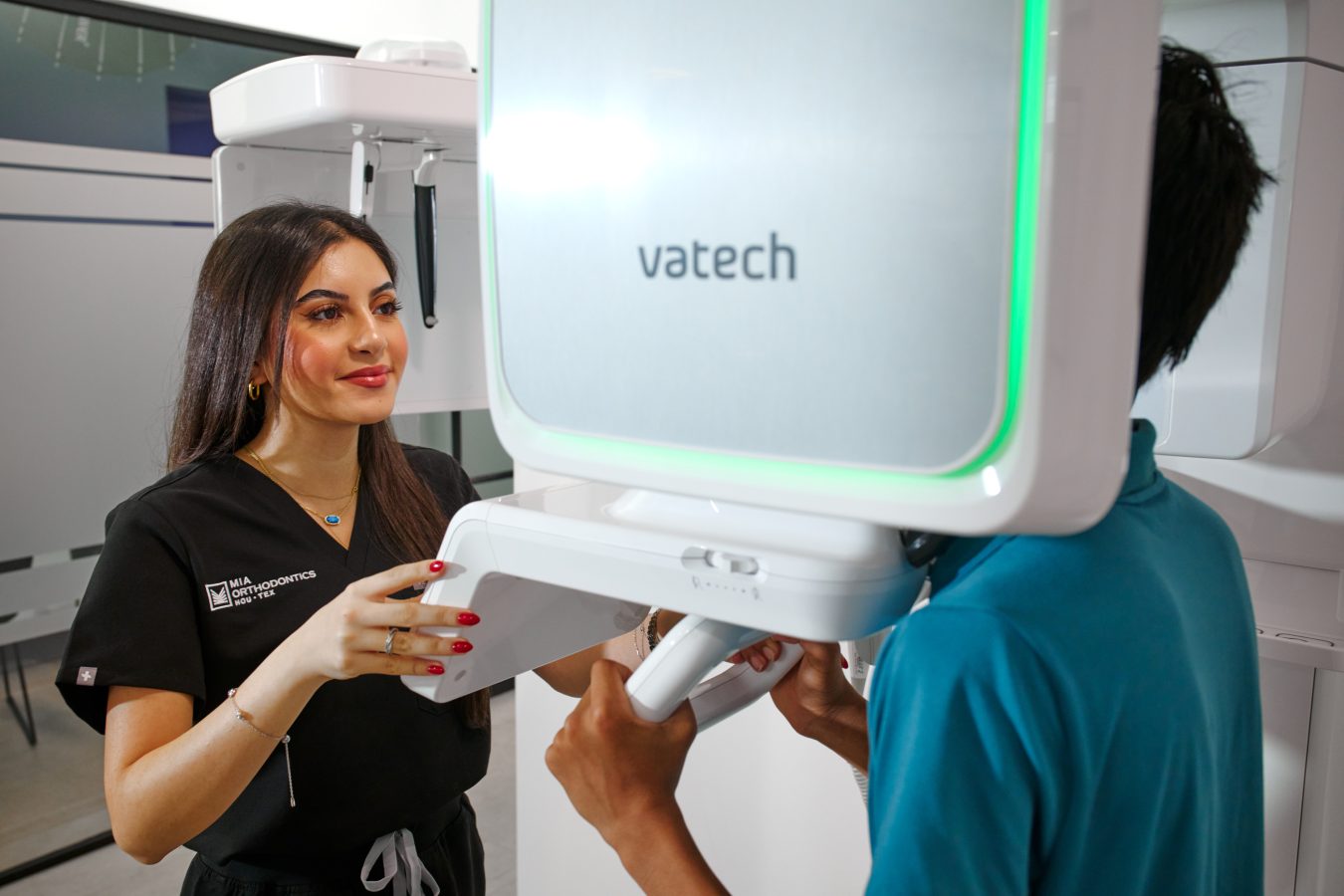 Dental professional performing X-ray on patient at Mia Orthodontics.